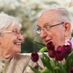 elderly couple with a bunch of tulips